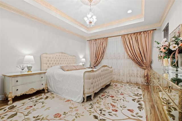 bedroom with ornamental molding, a raised ceiling, and an inviting chandelier