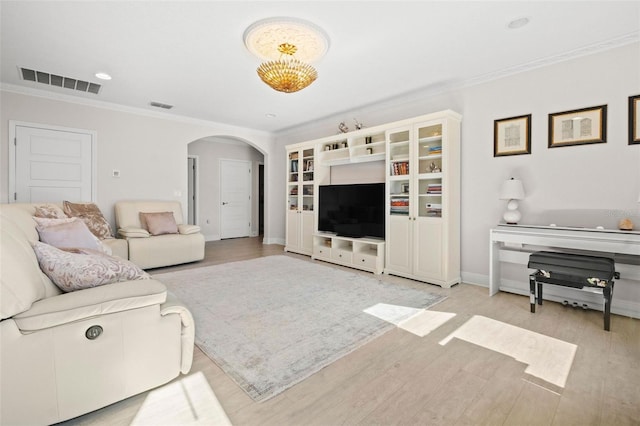 living room featuring light hardwood / wood-style floors and ornamental molding