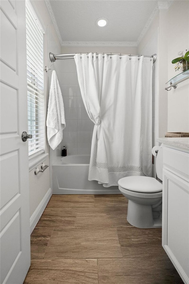 full bathroom featuring toilet, shower / tub combo, vanity, and ornamental molding