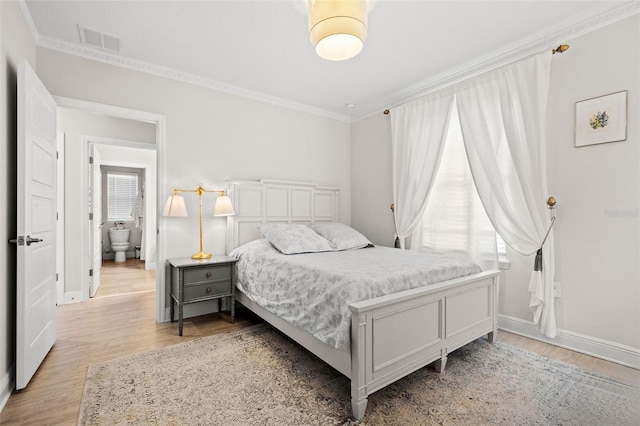 bedroom with ornamental molding, multiple windows, and light hardwood / wood-style flooring