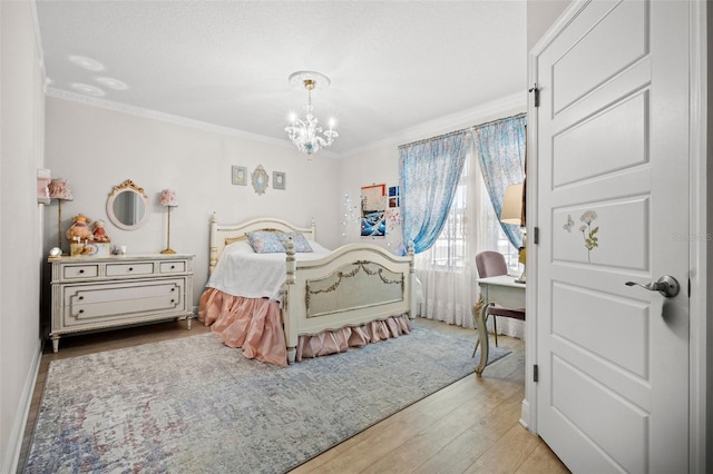 bedroom with light hardwood / wood-style floors, crown molding, and a chandelier