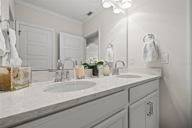 bathroom with vanity and crown molding