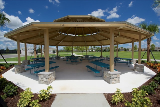 surrounding community with a gazebo and a yard