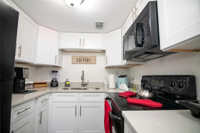 kitchen featuring white cabinets, sink, and black appliances