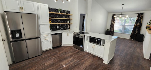 kitchen featuring kitchen peninsula, a chandelier, decorative light fixtures, white cabinets, and appliances with stainless steel finishes