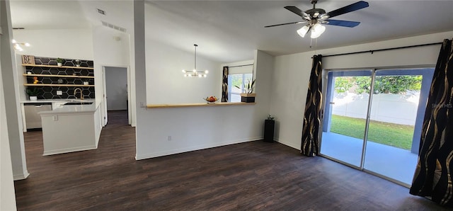 interior space featuring vaulted ceiling, plenty of natural light, dark wood-type flooring, and sink