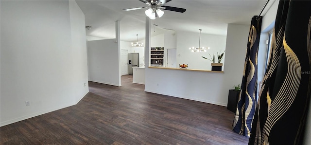 unfurnished living room featuring dark hardwood / wood-style floors, lofted ceiling, and ceiling fan with notable chandelier