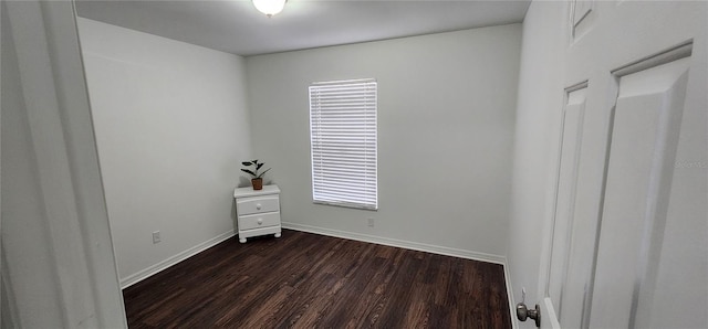 empty room featuring dark wood-type flooring