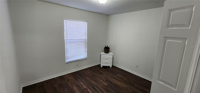 spare room featuring dark hardwood / wood-style flooring