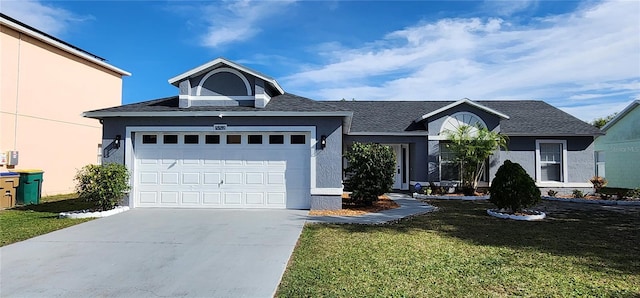 view of front of house with a garage and a front lawn