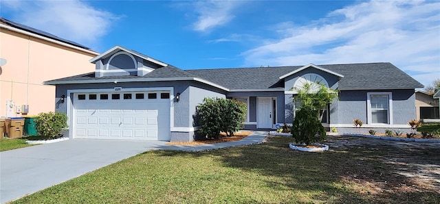 view of front of property with a front lawn and a garage