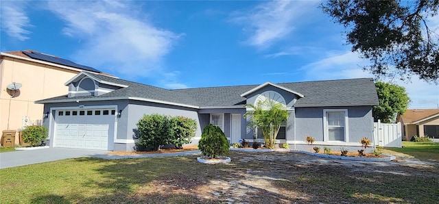 single story home with a front yard and a garage