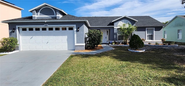 view of front of property featuring a garage and a front lawn