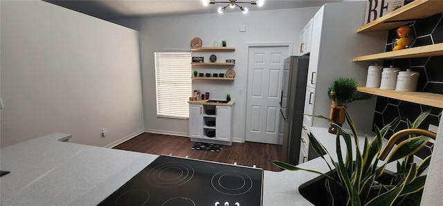 home office featuring dark hardwood / wood-style floors, a healthy amount of sunlight, and an inviting chandelier