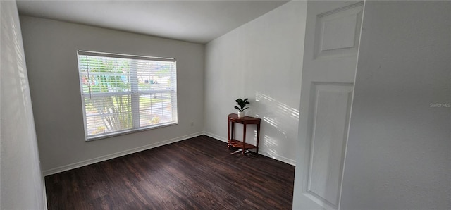 spare room with dark hardwood / wood-style flooring