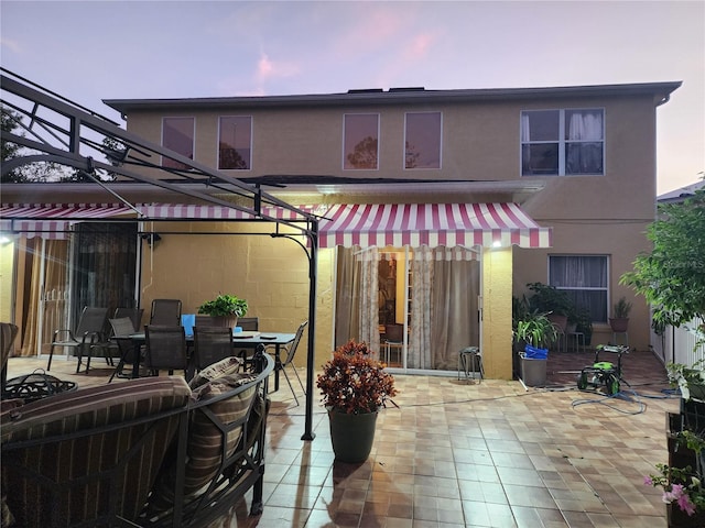 patio terrace at dusk with a pergola