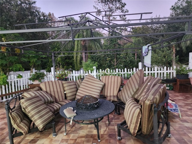 patio terrace at dusk featuring an outdoor fire pit