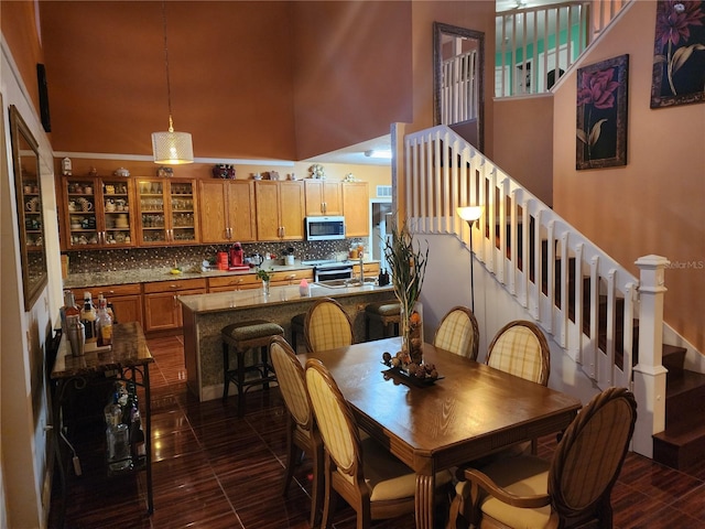 dining area with a towering ceiling