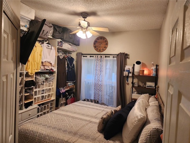 bedroom with a textured ceiling and ceiling fan