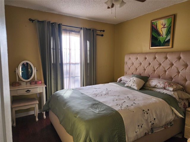 bedroom with ceiling fan, a textured ceiling, and hardwood / wood-style flooring