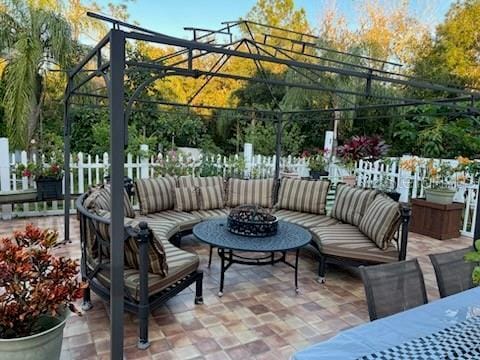 view of patio / terrace featuring an outdoor living space with a fire pit