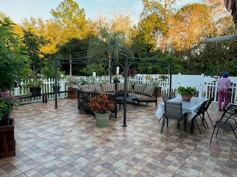 view of patio with fence and outdoor dining space