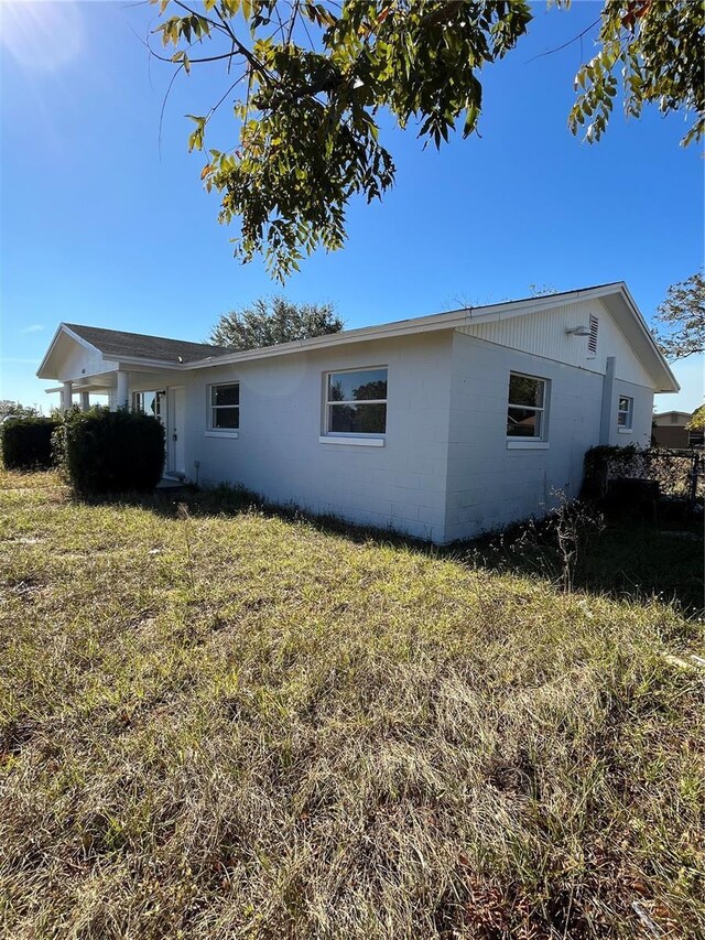 view of side of home featuring a yard