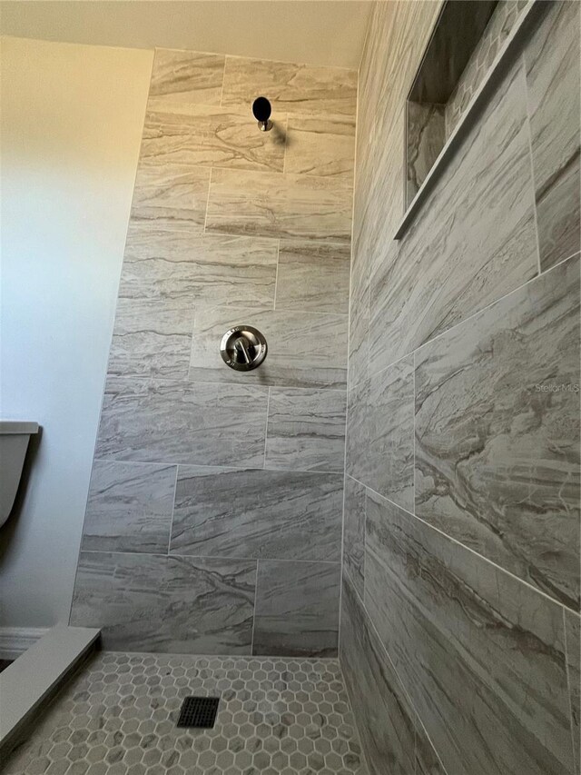 bathroom with tiled shower