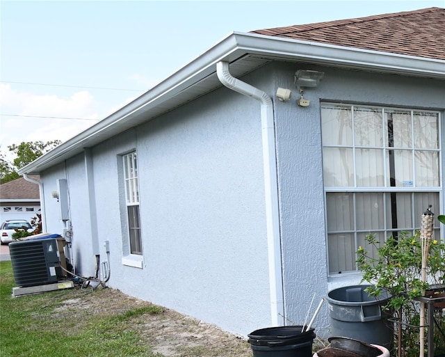 view of side of home featuring central AC unit