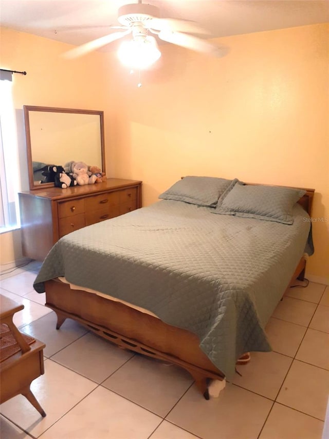 tiled bedroom featuring ceiling fan