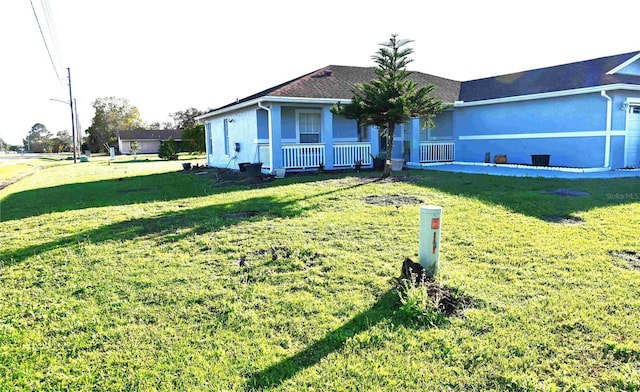 ranch-style house with covered porch, a front lawn, and stucco siding