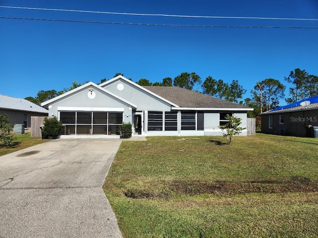 ranch-style house with a garage and a front lawn