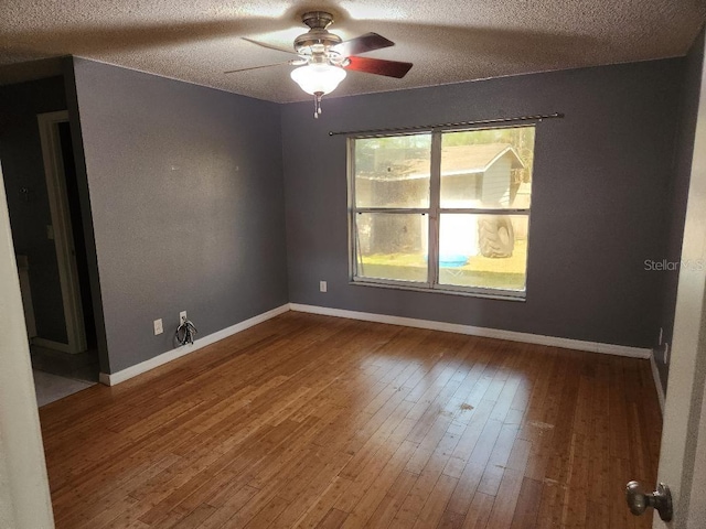 unfurnished room with wood-type flooring, a textured ceiling, and ceiling fan