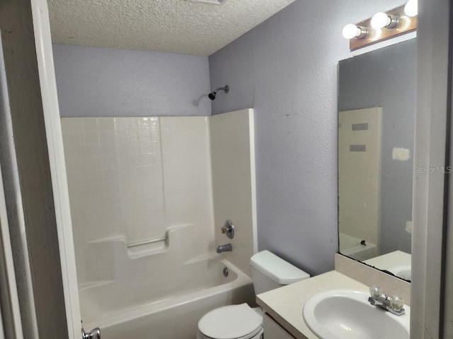 full bathroom with vanity, a textured ceiling, toilet, and  shower combination