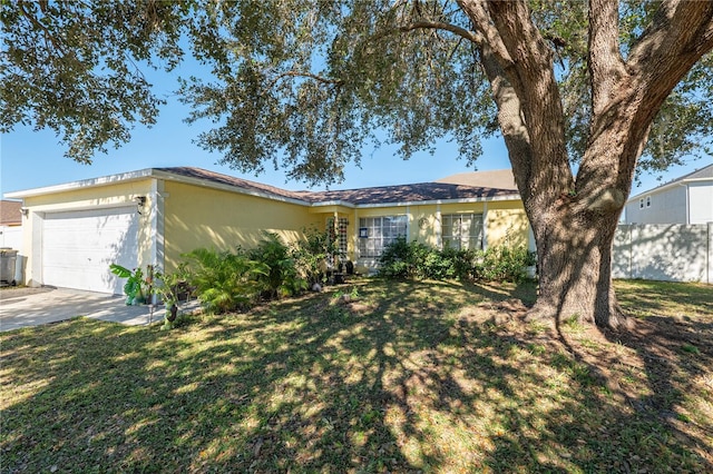 ranch-style home featuring a garage and a front yard