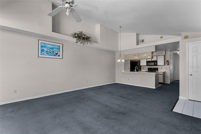 unfurnished living room with ceiling fan, dark carpet, a textured ceiling, and high vaulted ceiling