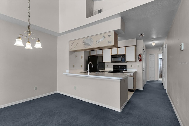 kitchen featuring sink, kitchen peninsula, a chandelier, decorative light fixtures, and black appliances