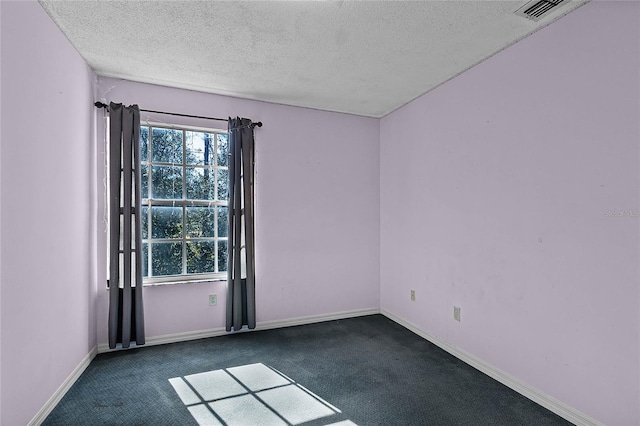 carpeted spare room with a textured ceiling