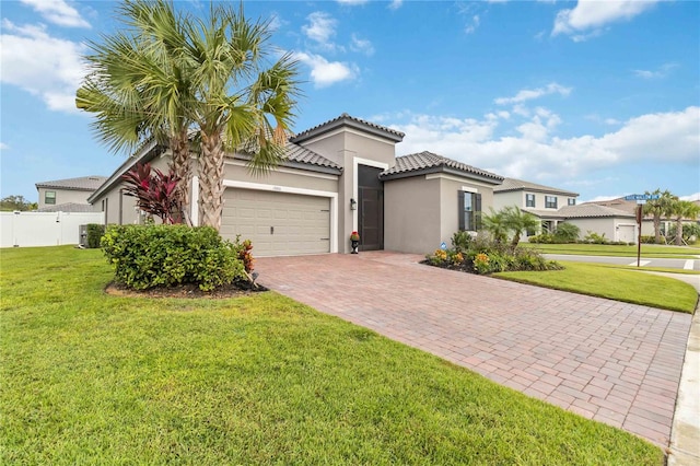 view of front of home with a front lawn and a garage