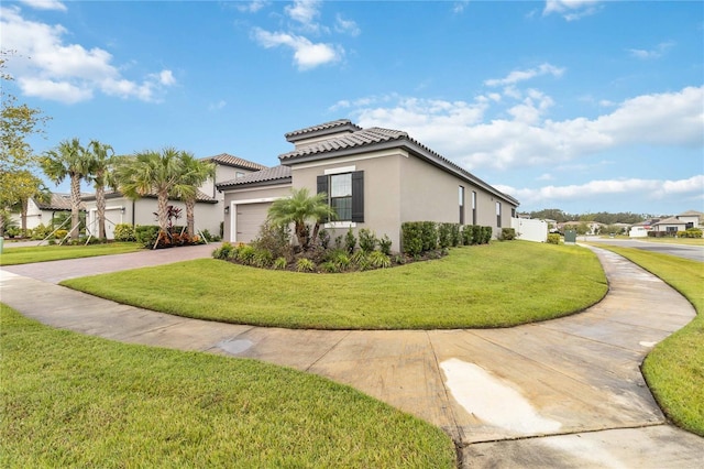 1880 Goblet Cove St, Kissimmee, FL 34746 - view of property exterior with driveway, stucco siding, an attached garage, and a yard