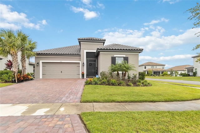 mediterranean / spanish-style home featuring a garage and a front lawn