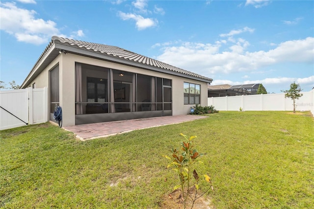 back of property featuring a yard and a patio