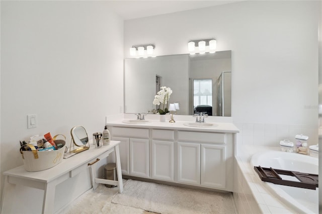 bathroom featuring shower with separate bathtub and vanity