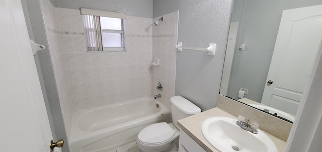 full bathroom featuring toilet, vanity, and tiled shower / bath