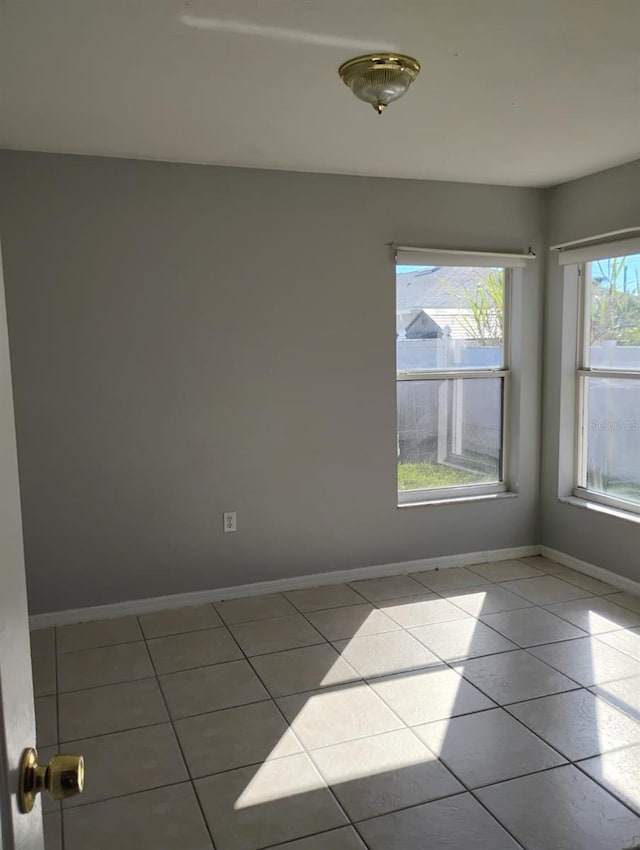 empty room featuring light tile patterned floors and a wealth of natural light