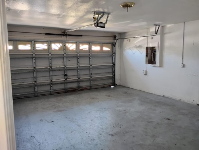 garage with electric panel and a garage door opener