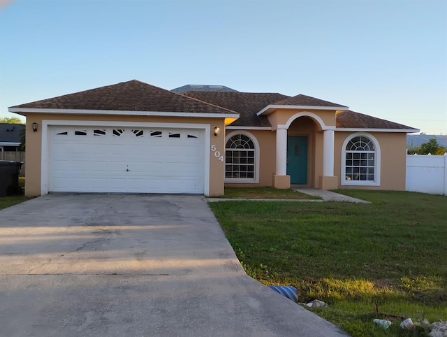 ranch-style home featuring a front yard and a garage