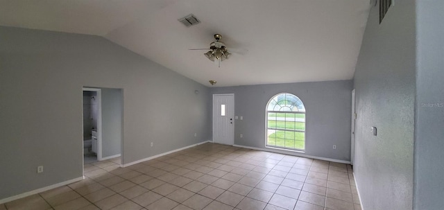 foyer featuring ceiling fan, light tile patterned floors, and vaulted ceiling