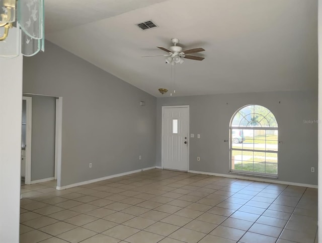 interior space with light tile patterned floors, vaulted ceiling, and ceiling fan