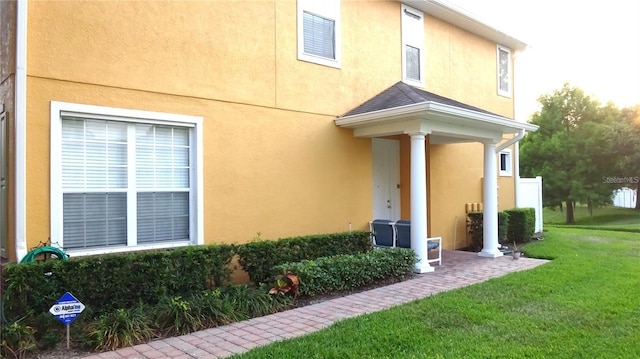 entrance to property featuring a yard